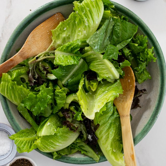 Fresh green salad with a fragrant orange herbed vinaigrette. Recipe by Melissa Huerta